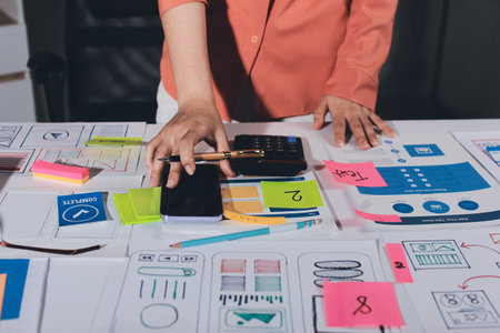 team of UI UX web designer are working together to develop mobile responsive websites with UI UX...