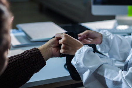 A doctor's hands carefully taking a patient's blood pressure using a sphygmomanometer.