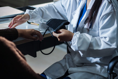 A doctor's hands carefully taking a patient's blood pressure using a sphygmomanometer.
