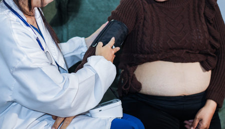 cropped shot of doctor examining pregnant woman during medical consultation