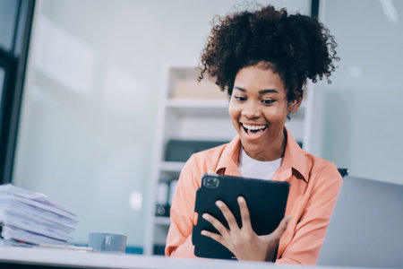 Smiling businesswoman working on laptop in office