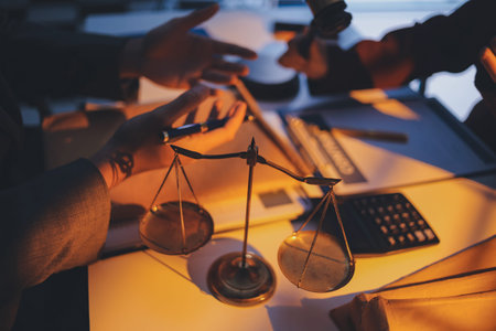 Close up of businessmen or lawyers discussing contract or business agreement at law firm office,...