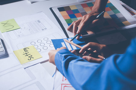 UXUI design brainstorming session with sketches and digital toolsの写真素材