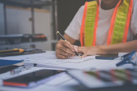 engineer and an architect reviewing blueprints and construction plans together