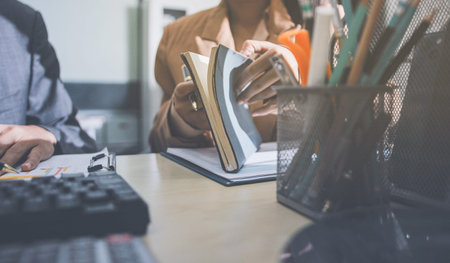 Accounting company provide finance and taxation planning for profitable cash flow, Auditor accountant working in office, analyze financial data and accounting record with calculatorの写真素材