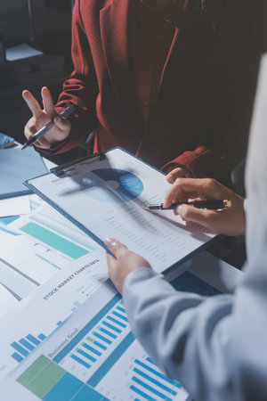 business people or accountant using calculator while working analytical business report on the...