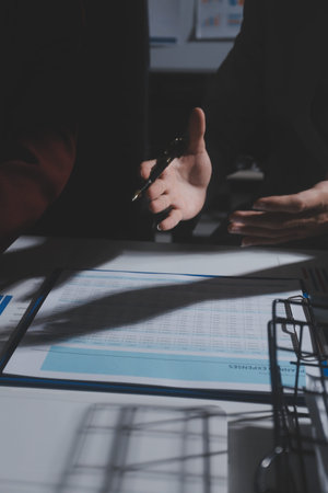 business people or accountant using calculator while working analytical business report on the...