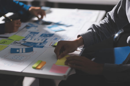 Team of Program Developer Collaborating on UXUI Design Planning in a Modern Office Environmentの写真素材