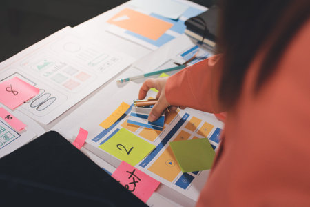 team of UI UX web designer are working together to develop mobile responsive websites with UI UX...