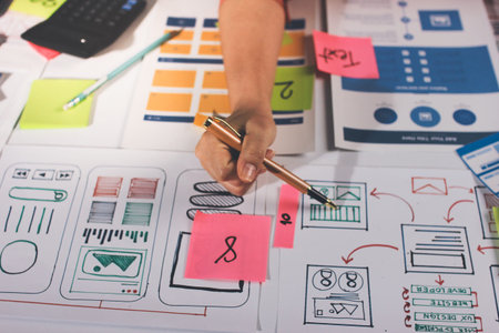 team of UI UX web designer are working together to develop mobile responsive websites with UI UX...