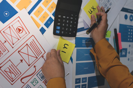 team of UI UX web designer are working together to develop mobile responsive websites with UI UX...