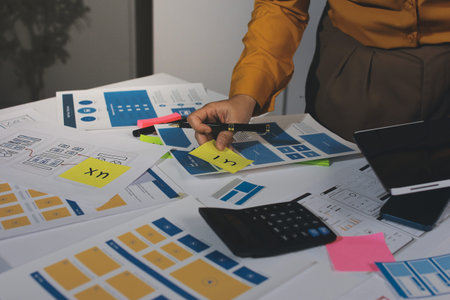 team of UI UX web designer are working together to develop mobile responsive websites with UI UX front end designer previews, UI UX web development ideas, front end designer. application developmentの写真素材