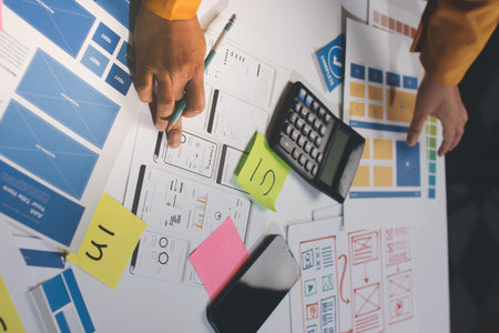 team of UI UX web designer are working together to develop mobile responsive websites with UI UX...