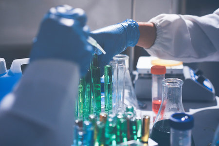 Science, laboratory and woman with pipette, test tube and biotech solution in research. Medical...