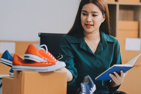 Starting small businesses SME owners female entrepreneurs check online orders to prepare to pack the...