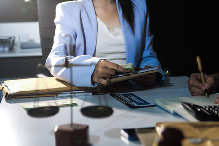 Consultation and conference of professional businesswoman and Male lawyers working and discussion having at law firm in office. Concepts of law, Judge gavel with scales of justiceの写真素材