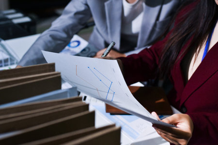 Business people analyzing monthly budget and financial report using data and chart to strategize and...