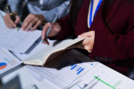 Business people analyzing monthly budget and financial report using data and chart to strategize and...