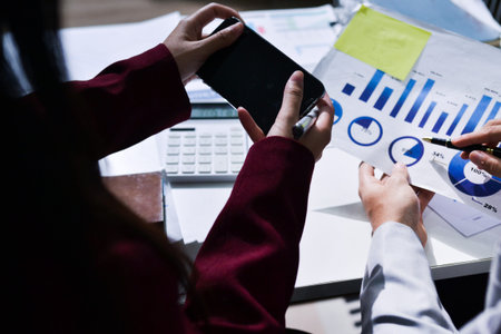 Business people analyzing monthly budget and financial report using data and chart to strategize and...