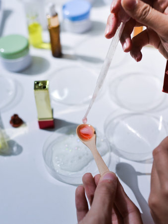 Woman making organic cosmetics with aloe in laboratory