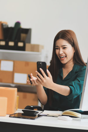 Starting small businesses SME owners female entrepreneurs check online orders to prepare to pack the boxes, sell to customers, sme business ideas online.の写真素材