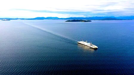 A white boat between islands, a romantic scene in wild natureの写真素材