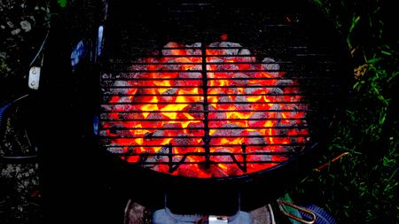 A close-up on the fire and the coal of a barbecueの写真素材