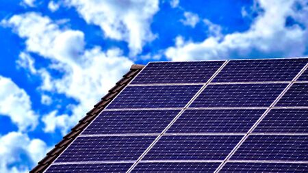 Solar panels on the roof of an house with clouds in background