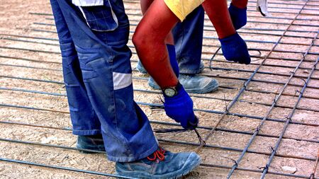 The arms of two men who are working in a conctructionの写真素材