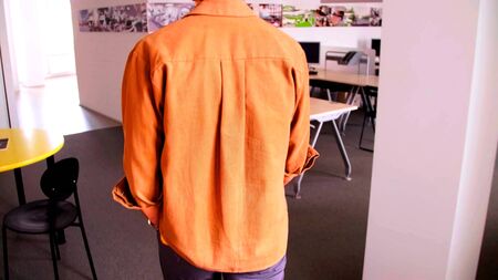 A photo of the back of a man who is coming in an officeの写真素材