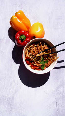 A top view of a bowl of Asian food with pepperの写真素材