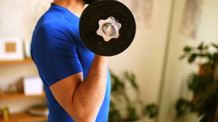 A focus on the arm of a man who is carrying an alters