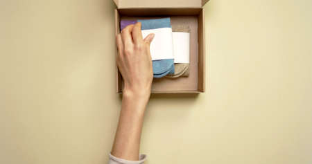 Hand of a woman who is taking socks in a box
