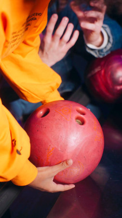 A boy is holding a bowling ballの写真素材