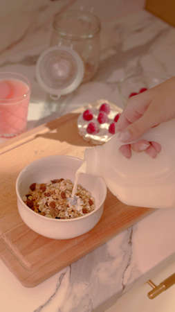 A woman is preparing a Bowl of cereal