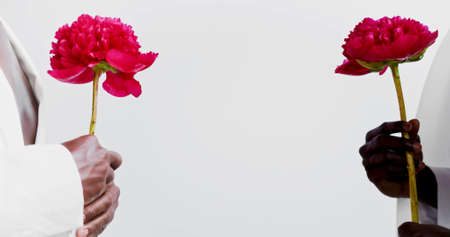 A background photo with black hands which are holding flowerの写真素材