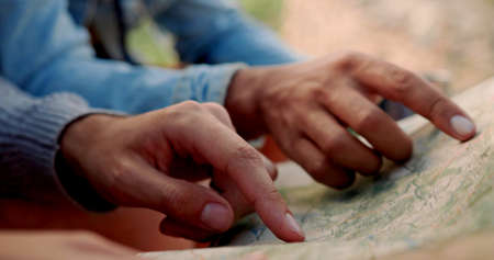 Hands of men who are reading a map
