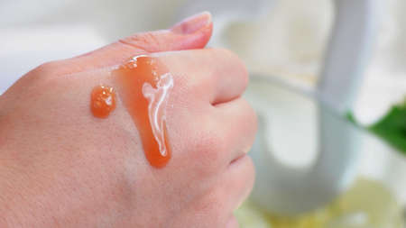 A beauty cream on the hand of a womanの写真素材
