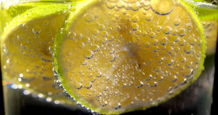 Focus on bubbles on a lemon in a glassの写真素材