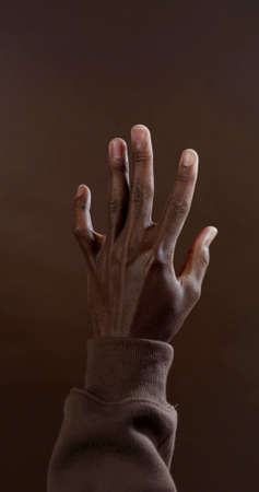 A vertical photo of a black handの写真素材