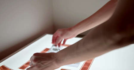 A man is watching a photo negativeの写真素材