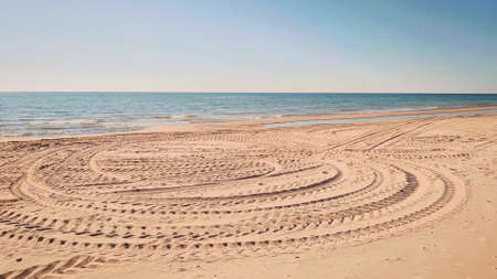 Tire tracks on the beachの写真素材