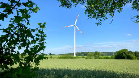 A photo of a wind turbine in nature