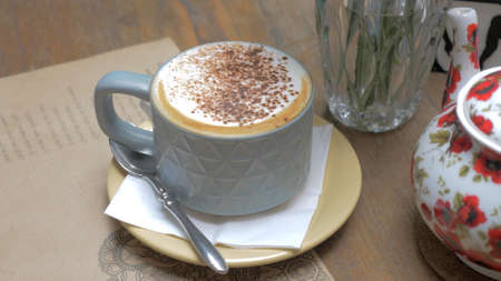 A photo of a cream coffee on a table