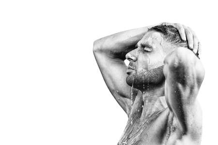 Handsome, attractive, muscular man in shower on a white background. Skin care, washing. Isolatedの写真素材