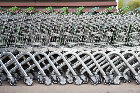 row of shopping trolleys or carts in supermarketの写真素材