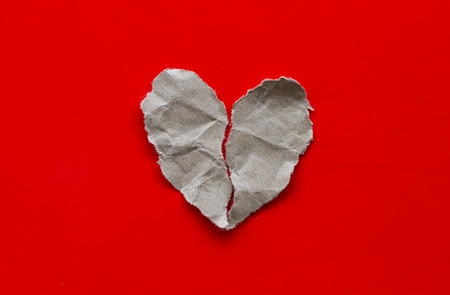 broken heart, isolated on red backgroundの写真素材