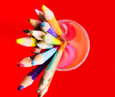 color pencils isolated on red backgroundの写真素材