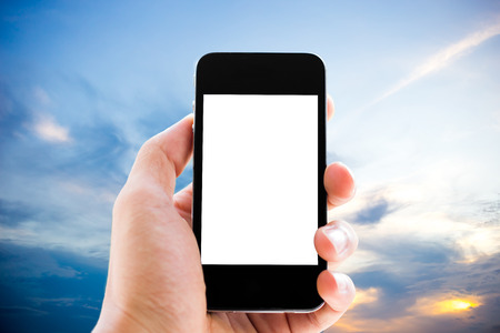 hand holding phone with sky backgroundの写真素材