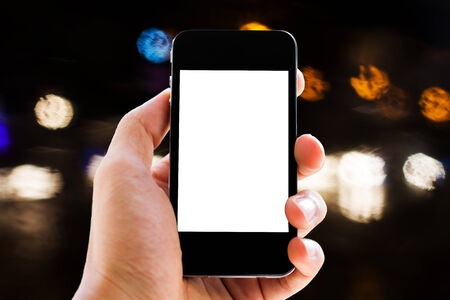 hand holding phone with light abstract backgroundの写真素材